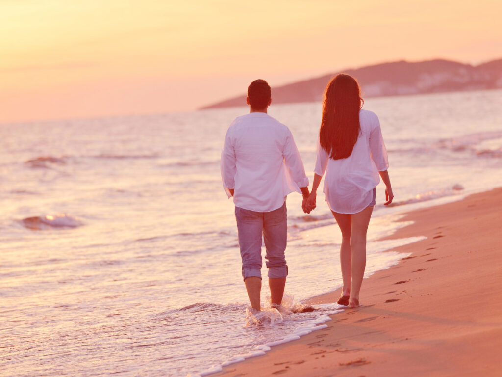 Taking a leisurely stroll on the beach at sunset is one of the most romantic things to do in Destin, Florida.